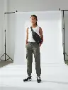 Teenager in cargos with a sling bag, white studio backdrop.__ (2).webp